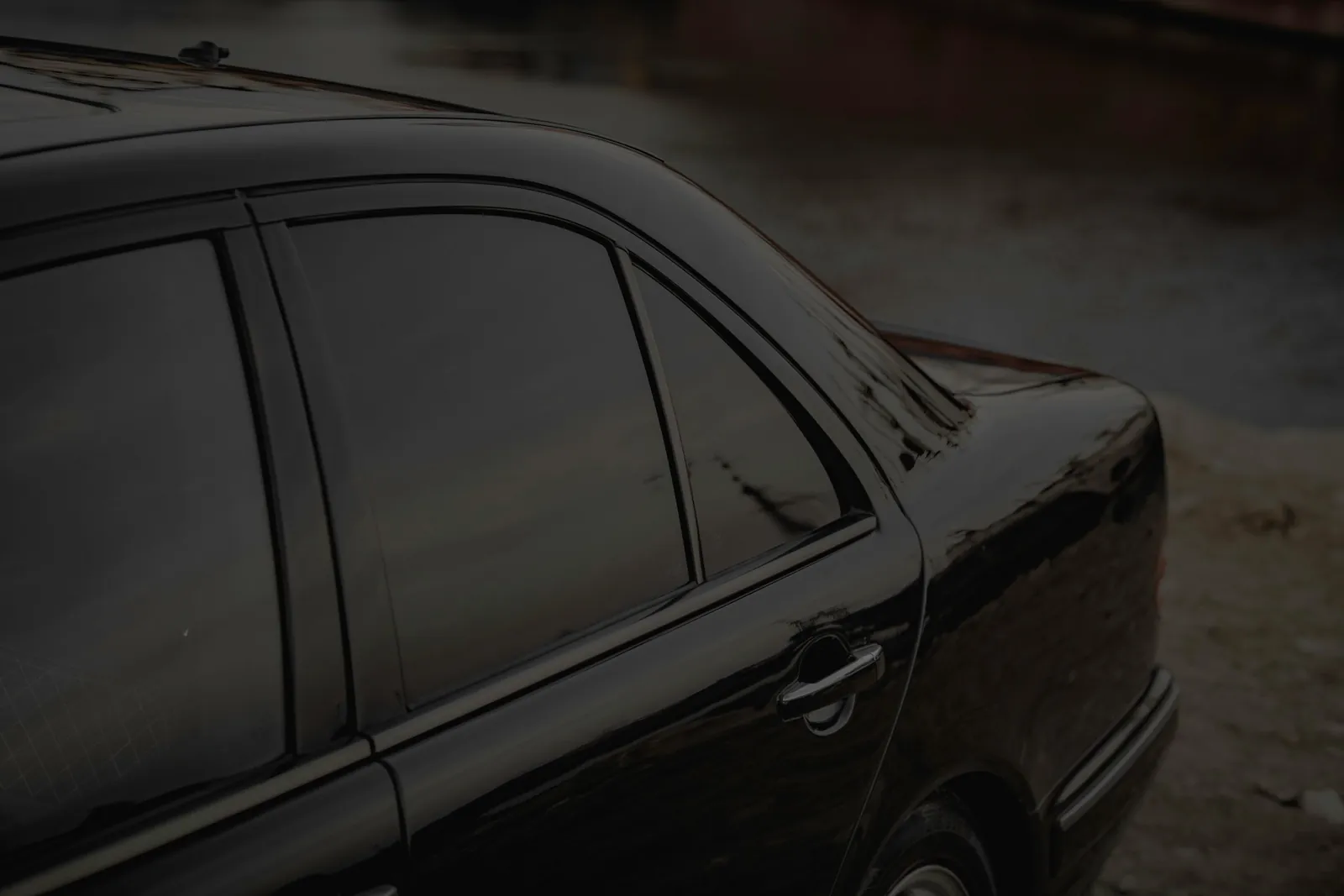 Carro preto com vidros laterais escurecidos por película